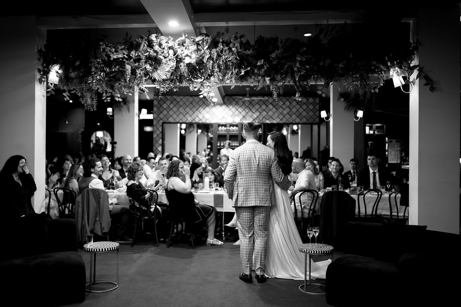 Newlyweds walking past guests at their reception